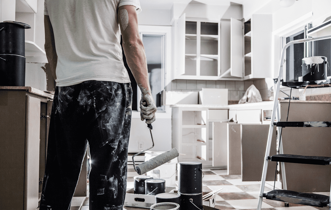 Photo of painter preparing to paint kitchen cabinets